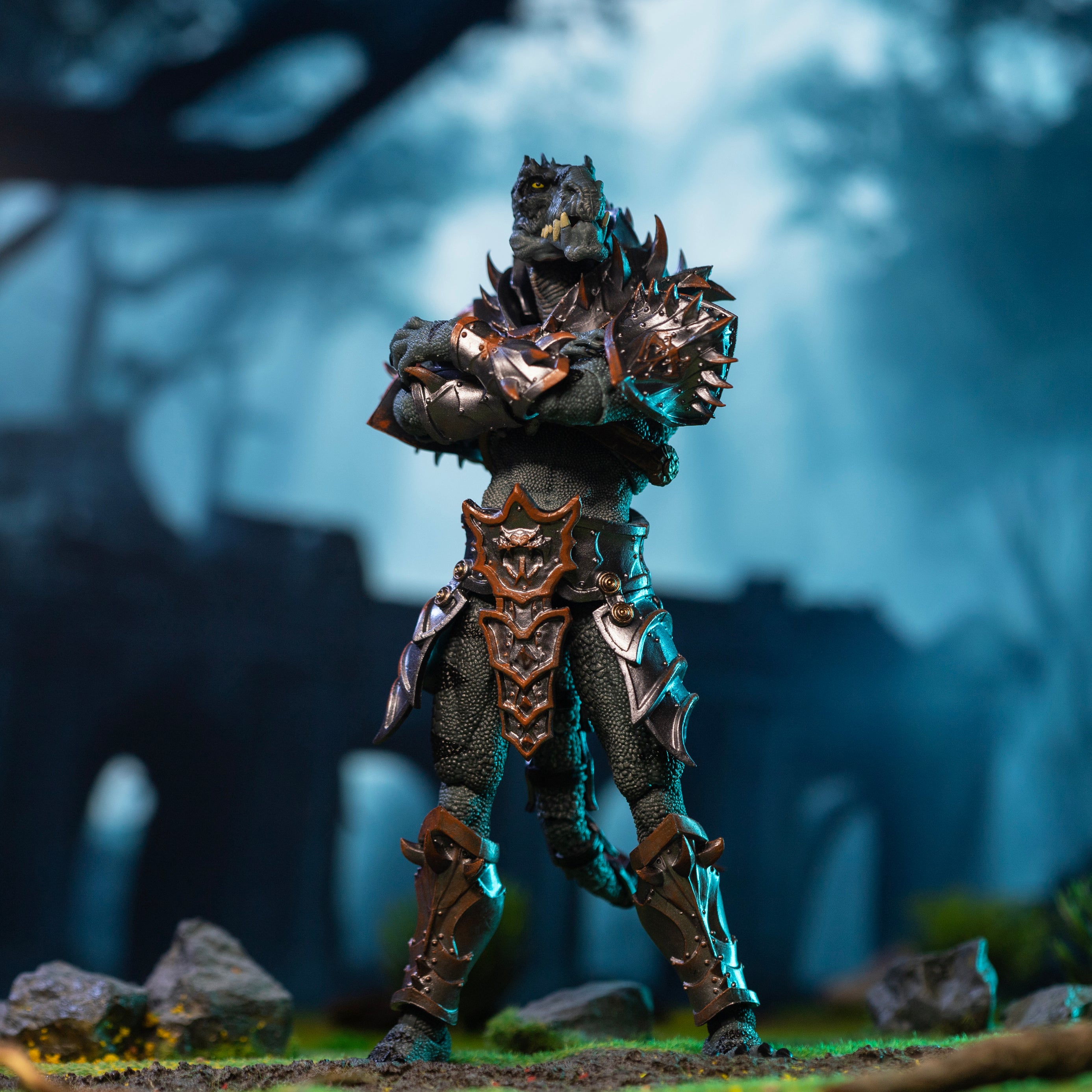 Fully armored green Saurian standing at ease with arms crossed in front of forest ruins.